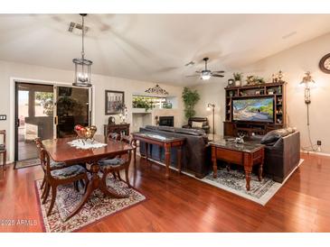 Inviting living room with hardwood floors, fireplace, and comfortable seating area at 16292 N Naegel Dr, Surprise, AZ 85374