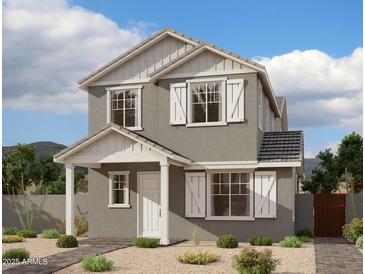 Charming two-story home with white trim, shutters, well-manicured landscaping, and neutral color palette at 1970 W Lariat Ln, Phoenix, AZ 85085