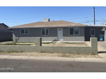 Charming single-story home with a low-walled yard, showcasing a neat and inviting facade under a clear sky at 2010 N 38Th Ave, Phoenix, AZ 85009