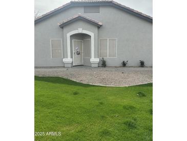 Charming single-story home featuring a well-maintained front yard and covered entryway at 20625 N 104Th Ave, Peoria, AZ 85382