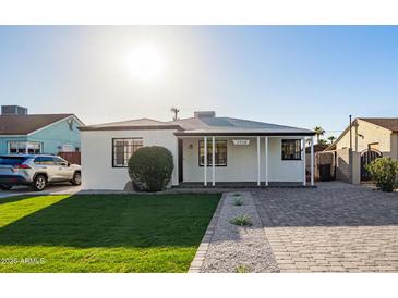 Charming single-story home with a well-maintained lawn, walkway, and covered front porch at 2938 N 15Th Ave, Phoenix, AZ 85015