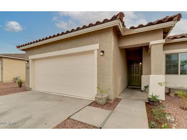 Inviting single-story home showcasing a two car garage and a well-maintained desert landscape at 3010 N Majestic Ct, Casa Grande, AZ 85122