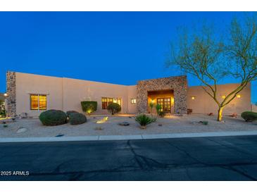 Desert home features a front yard with xeriscaping and a stone accent entry at 37015 N 27Th Pl, Cave Creek, AZ 85331