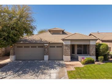 Charming single story home featuring a three-car garage, low maintenance landscaping, and a tile roof at 7214 N 88Th Ln, Glendale, AZ 85305