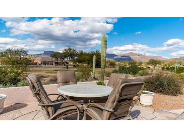 Outdoor patio featuring a dining table with mountain views, perfect for entertaining or enjoying the desert scenery at 7380 E Canyon Wren Dr, Gold Canyon, AZ 85118