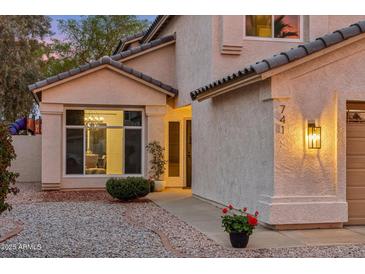 Inviting home exterior featuring a charming facade, desert landscaping, and warm lighting at 741 N Cholla St, Chandler, AZ 85224