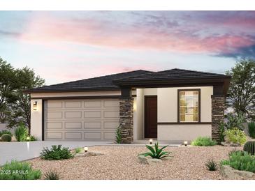 Charming single-story home with desert landscaping, stone accents, and a two-car garage at 1698 S 246Th Ln, Buckeye, AZ 85326