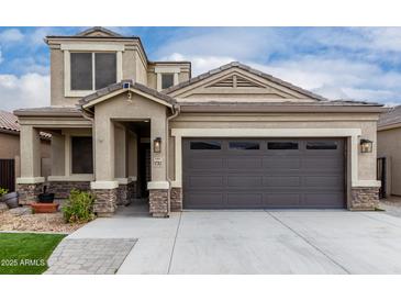 Stunning two-story home showcasing a well-manicured lawn and attractive exterior features at 17263 N Bala Dr, Maricopa, AZ 85138