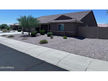 Charming single-story home featuring low-maintenance landscaping and a neutral color palette at 3829 N Princeton Ln, Casa Grande, AZ 85122