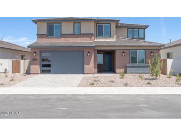 Two-story home featuring a neutral color palette, large garage, and low maintenance desert landscaping at 40147 N Alameda Dr, San Tan Valley, AZ 85140
