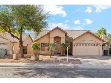 Inviting single-Gathering home featuring a well-maintained front yard, desert landscaping, and a two-car garage at 4693 W Tara Dr, Chandler, AZ 85226