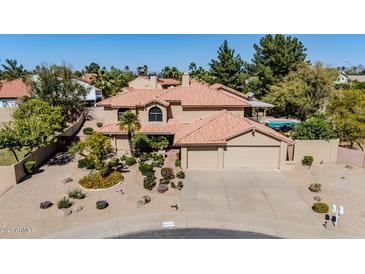 Stunning two-story home featuring a desert landscape, red tile roof, and attached two-car garage at 6334 E Le Marche Ave, Scottsdale, AZ 85254