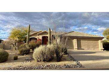 Charming single-story home with a desert landscaped front yard and attached two-car garage at 9142 E La Posada Ct, Scottsdale, AZ 85255