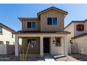 Charming two-story home with a cozy front porch and craftsman architectural details at 15586 S 181St Dr, Goodyear, AZ 85338