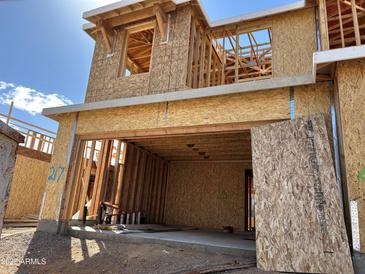 View of a home under construction showing the framing, sheathing, and garage door, sunny sky at 21232 N 58Th St, Phoenix, AZ 85054