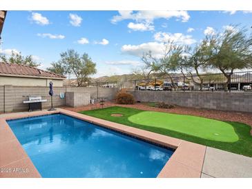 Private backyard with pool, putting green, BBQ, and mountain views, perfect for outdoor entertaining at 315 E Milada Dr, Phoenix, AZ 85042