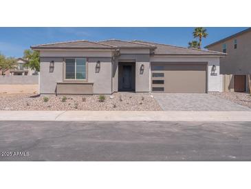 Beautiful single-story home with a modern design, desert landscaping, and a two-car garage at 40165 N Alameda Dr, San Tan Valley, AZ 85140