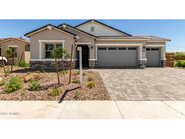 Charming single-story home with desert landscaping and a two-car garage on a sunny day at 12029 W Marguerite Ave, Avondale, AZ 85323