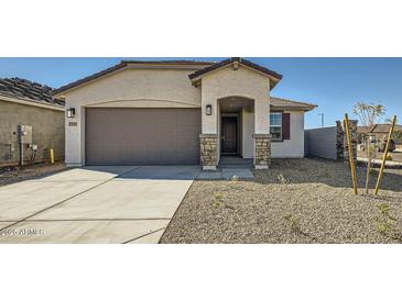 Inviting single-Gathering home boasting a two-car garage and desert landscaping at 15065 W Hackamore Dr, Surprise, AZ 85387