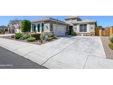 Charming single-story home with desert landscaping and a spacious concrete driveway at 19672 N 260Th Ave, Buckeye, AZ 85396