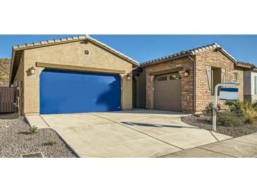 Charming single-story home featuring stucco and brick facade, two-car garage, and well-maintained landscaping at 3252 W Peak View Rd, Phoenix, AZ 85083