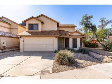 Charming two-story home with a two-car garage and desert landscaping under a bright blue sky at 405 E Wescott Dr, Phoenix, AZ 85024