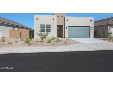 Contemporary home featuring desert landscaping, a gray garage door, and a light stucco exterior at 4050 W Nora Dr, San Tan Valley, AZ 85144