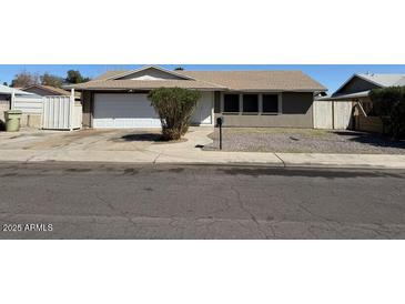 Single-story home with a large front yard, gravel landscaping, and a two-car garage at 5639 N 46Th Ave, Glendale, AZ 85301