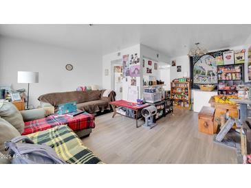 Comfortable living room with a couch and an interesting open floorplan; the room is brightly lit and welcoming at 12123 W Bell Rd # 315, Surprise, AZ 85378