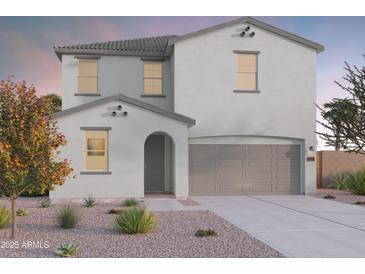 Charming two-story home with a neutral color scheme, a two-car garage, and desert landscaping at 12556 W Trumbull Rd, Avondale, AZ 85323
