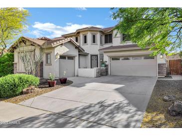 Beautiful two-story home with a three-car garage and a well-manicured front yard at 29374 N 125Th Dr, Peoria, AZ 85383