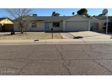 Charming single-story home featuring a well-maintained front yard and a two-car garage at 3515 E Winchcomb Dr, Phoenix, AZ 85032
