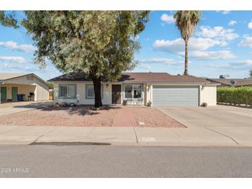 Charming single-story home with a well-manicured front yard and attached two-car garage at 419 N Valencia Dr, Chandler, AZ 85226