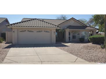 Charming single-story home with a two-car garage and meticulously maintained desert landscaping at 6005 E Selkirk Cir, Mesa, AZ 85215