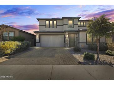 Charming two-story home boasts a well-manicured front yard and welcoming curb appeal at 11607 W Marguerite Ave, Avondale, AZ 85323