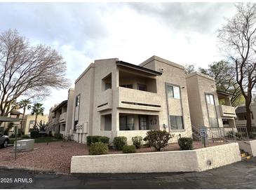 Modern condo building featuring a stucco exterior, balconies, desert landscaping and a speed limit sign of 15 mph at 145 N 74Th St # 236, Mesa, AZ 85207