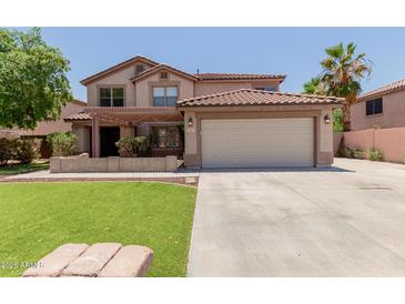 Inviting two-story home featuring a two-car garage, well-manicured lawn, and a charming covered porch at 3397 E Derringer Way, Gilbert, AZ 85297