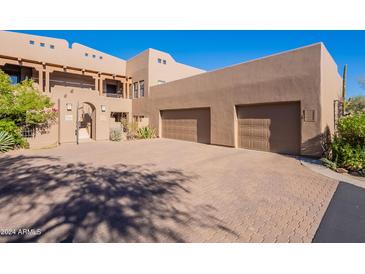 Inviting two-story home featuring a private entry and a spacious two-car garage at 36601 N Mule Train Rd # B14, Carefree, AZ 85377