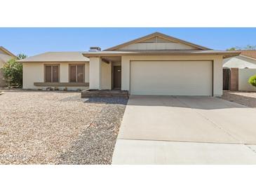Charming single-story home featuring a two-car garage and low-maintenance desert landscaping at 519 W Palomino Dr, Chandler, AZ 85225