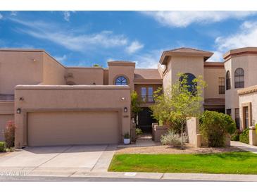 Charming two-story home with a well-manicured lawn, covered garage, and beautiful architectural details at 8100 E Camelback Rd # 138, Scottsdale, AZ 85251
