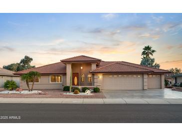 Charming desert home with tile roof, three-car garage, and low-maintenance landscaping at 10843 E Kilarea Ave, Mesa, AZ 85209