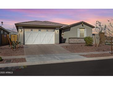 A well maintained home featuring low maintenance landscaping in the front yard at 17286 W Running Deer Trl, Surprise, AZ 85387
