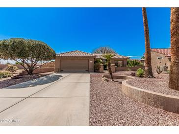 Charming single-story home with desert landscaping, tile roof, and inviting curb appeal at 18014 N Calypso Ct, Surprise, AZ 85374