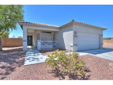 Well-maintained home featuring desert landscaping, a welcoming front porch, and a two-car garage at 1825 E Sycamore Rd, Casa Grande, AZ 85122
