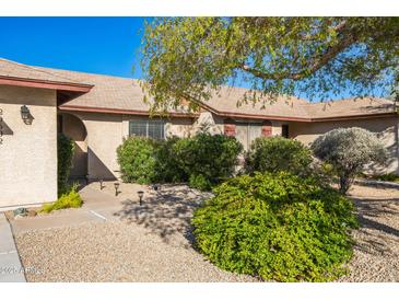 Landscaped front yard featuring mature desert vegetation and a walkway to the front door at 20602 N 31St Dr, Phoenix, AZ 85027