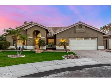 Inviting single-story home featuring a tile roof, desert landscaping, and a two-car garage at 21 W Pecan Pl, Tempe, AZ 85284