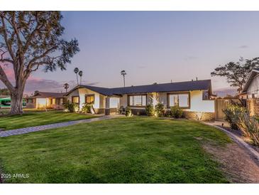 Beautifully landscaped single-story home with large front yard and mature trees at 3016 N 49Th St, Phoenix, AZ 85018