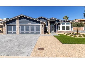 Charming single-Gathering home featuring a three-car garage, manicured landscaping, and modern design at 4536 E Beck Ln, Phoenix, AZ 85032