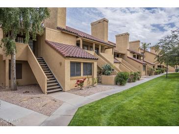 Charming townhome featuring traditional Southwest architecture, red tile roof, and well-maintained landscaping at 4901 S Calle Los Cerros Dr # 236, Tempe, AZ 85282