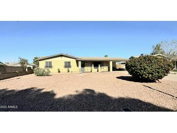 Charming single-story home with well-maintained landscaping and a covered carport on a sunny day at 9425 N 38Th Ave, Phoenix, AZ 85051